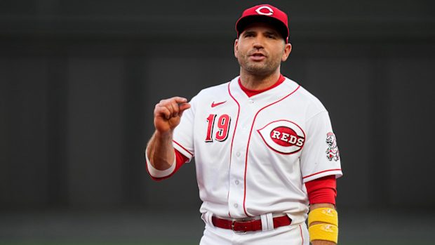 Reds first baseman Joey Votto chats with umpire Ryan Blakney.